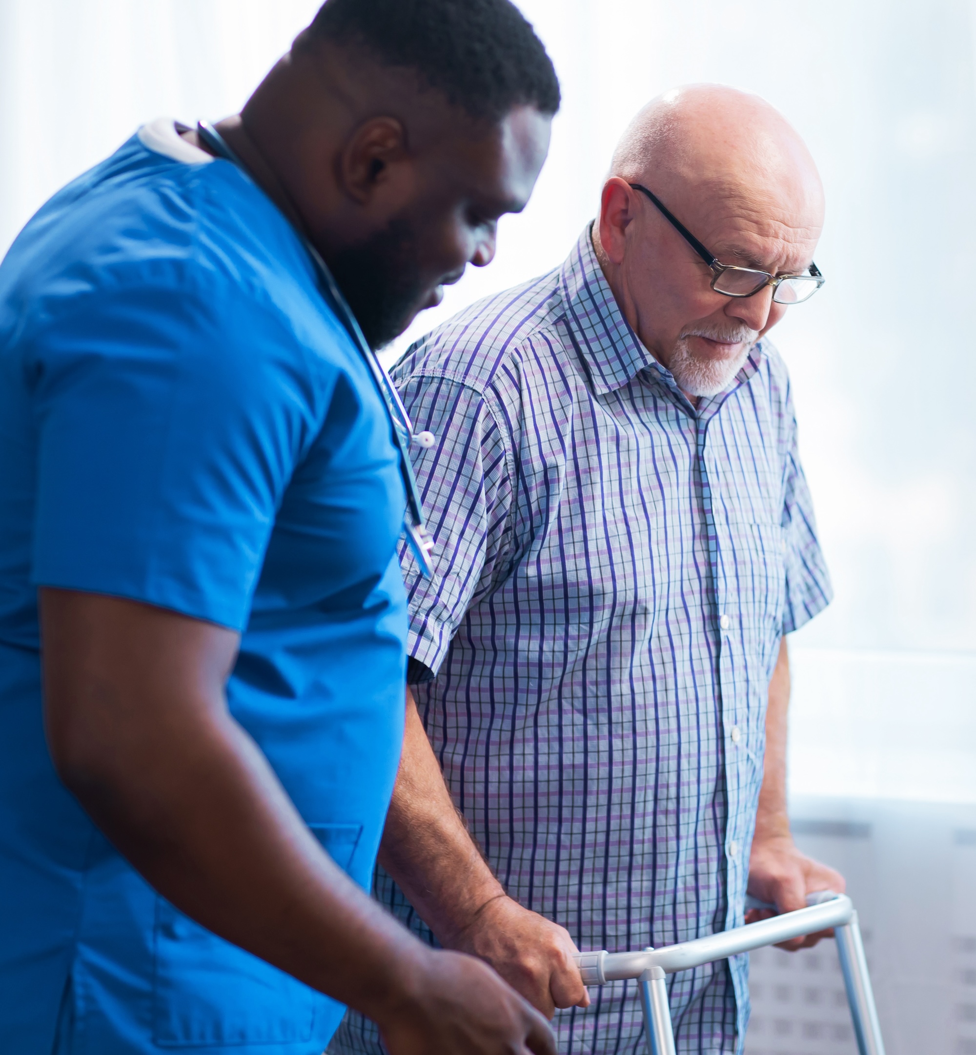 Caregiver assisting a senior with mobility and safe movement