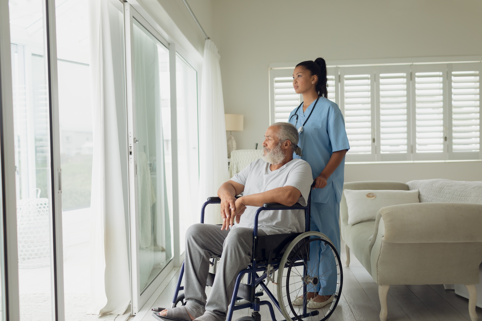 Caregiver providing attentive respite care for a senior at home